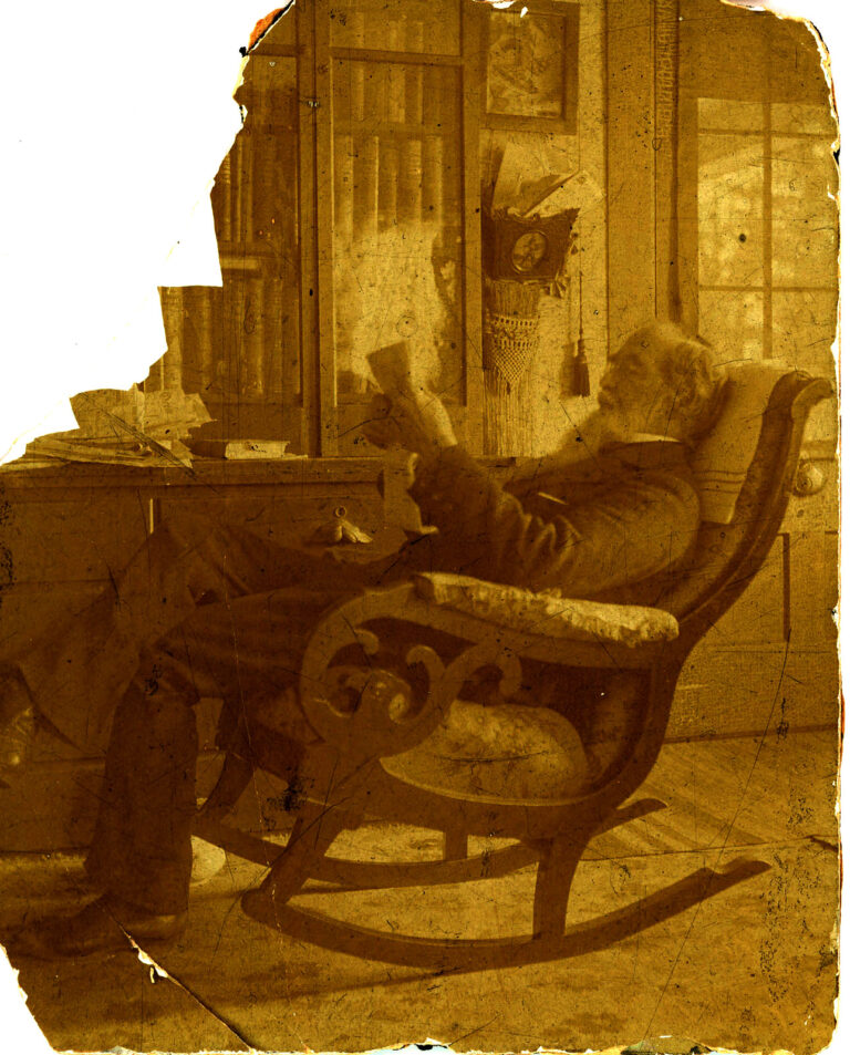 Matthew Canfield Read seated in a rocking chair reading