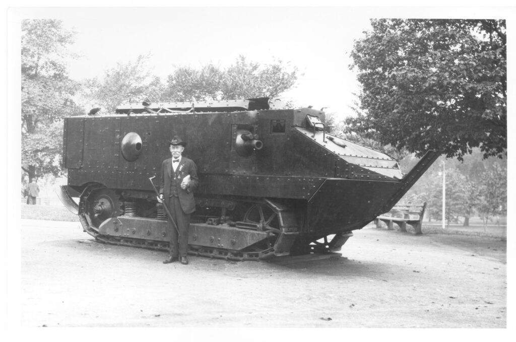 Samuel Rideout (in Civil War uniform), standing in front of a French WWI era tank